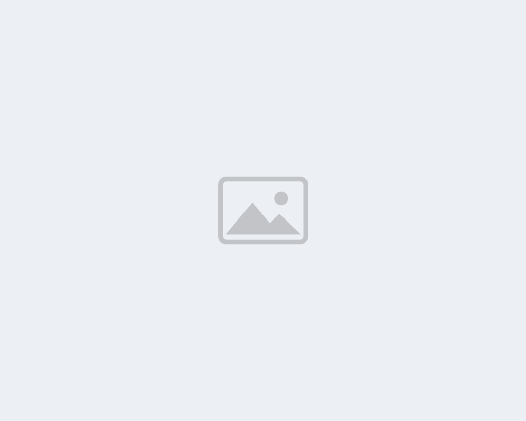 Photo placeholder - replace with plumber installing drain under kitchen sink, toolbox on floor